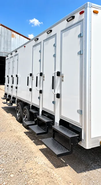 Combination shower-restroom trailer side view with entry steps