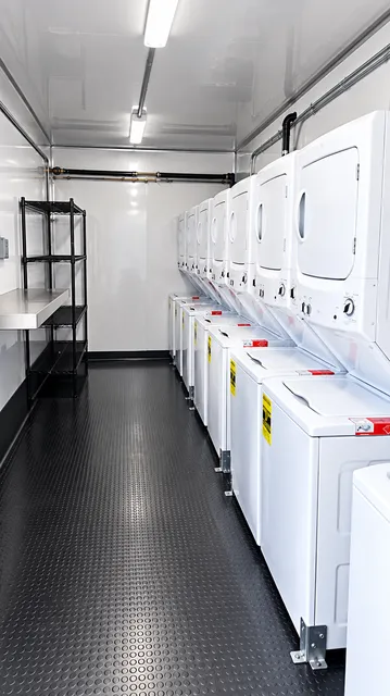Laundry trailer interior with washers and dryers