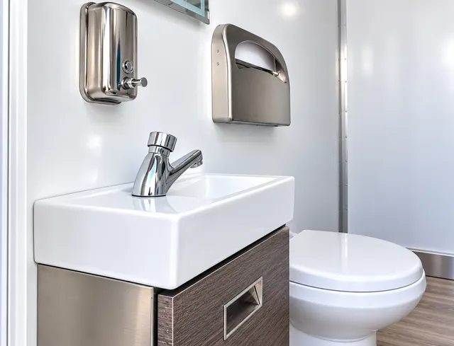 Restroom interior with vanity and toilet